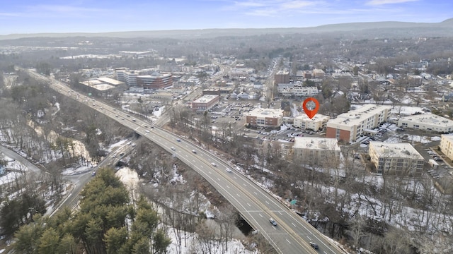 drone / aerial view featuring a city view and a mountain view