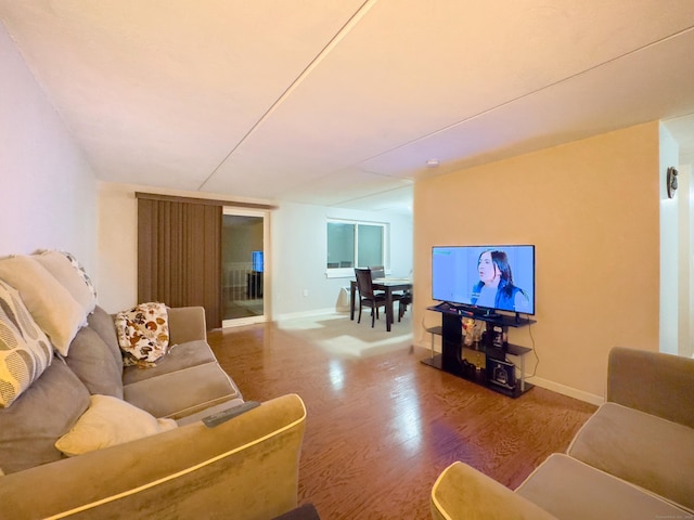 living room featuring baseboards and wood finished floors