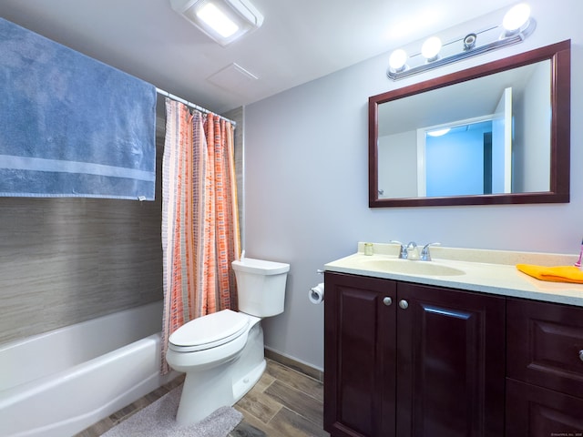 bathroom featuring toilet, shower / bathtub combination with curtain, wood finished floors, and vanity