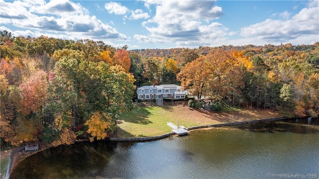 drone / aerial view featuring a water view and a wooded view