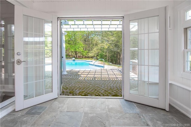 doorway to outside with stone tile flooring