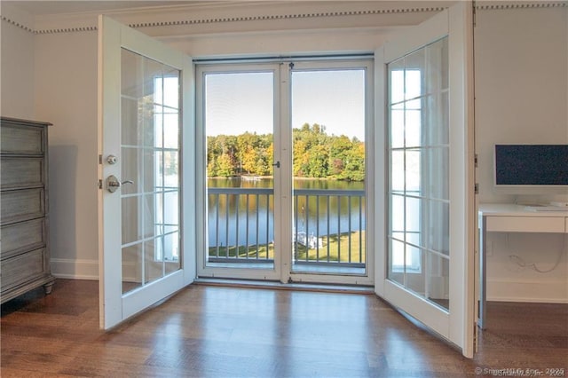 doorway with wood finished floors and baseboards