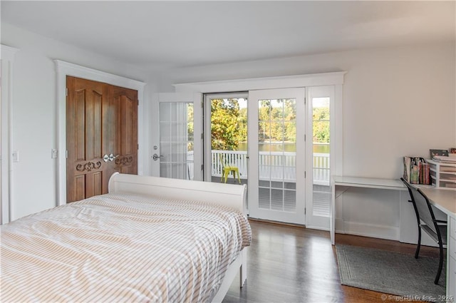 bedroom with access to outside and wood finished floors