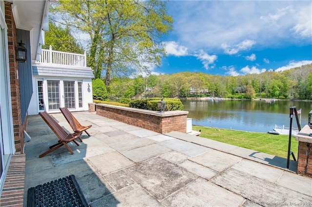 view of patio with french doors and a water view