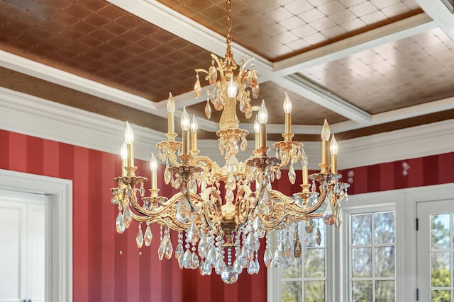 room details with a chandelier, ornamental molding, and wallpapered walls