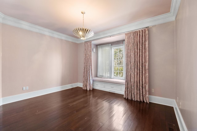 spare room featuring baseboards, dark wood finished floors, and crown molding