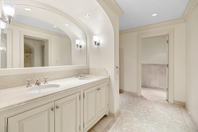 bathroom with recessed lighting, crown molding, a sink, and double vanity