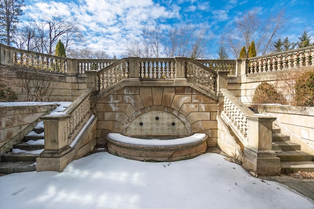 snow covered patio with stairway