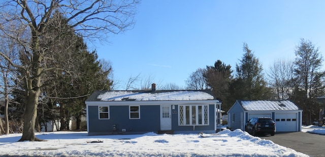 324 Maple St, Branford, CT 06405 - view of front of house with an outdoor structure, a chimney, and a garage