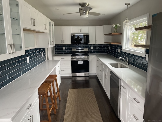 324 Maple St, Branford, CT 06405 - kitchen with open shelves, a sink, decorative backsplash, appliances with stainless steel finishes, and dark wood-style flooring
