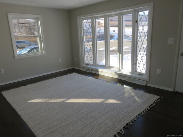 324 Maple St, Branford, CT 06405 - unfurnished room featuring baseboards, dark wood-style flooring, visible vents, and plenty of natural light