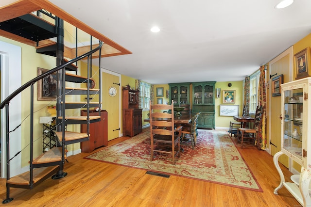 dining room featuring stairway, recessed lighting, and wood finished floors