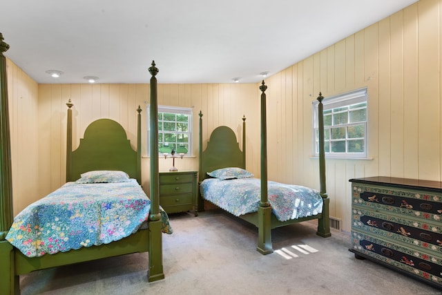 bedroom with visible vents and carpet