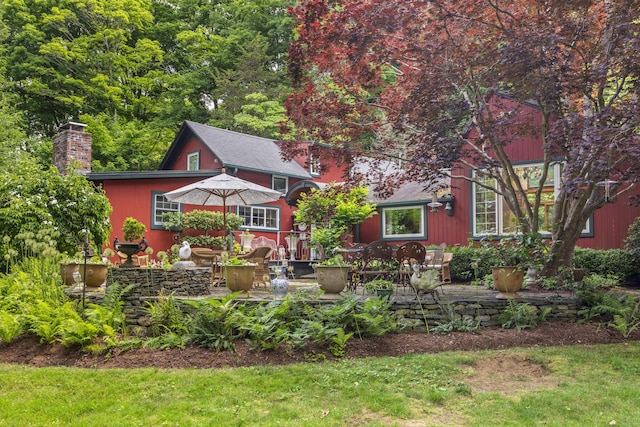 view of front of property with a chimney and a patio area