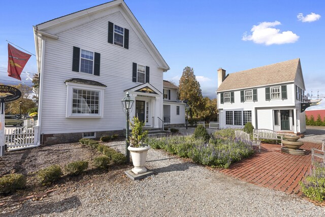 view of front of house featuring a chimney