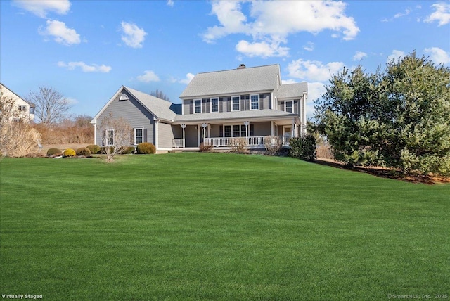 back of house with a porch and a yard