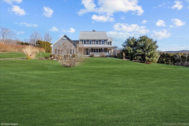 back of house with a lawn