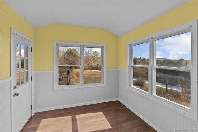 unfurnished sunroom featuring vaulted ceiling and a healthy amount of sunlight