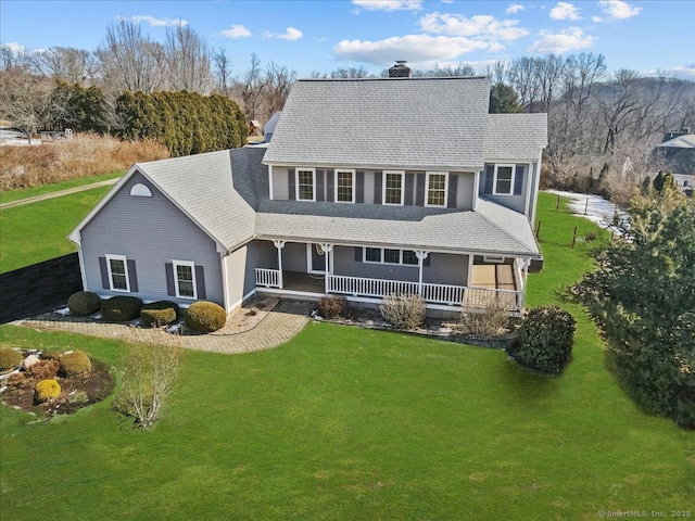 view of front of property with a front lawn, a chimney, and a porch