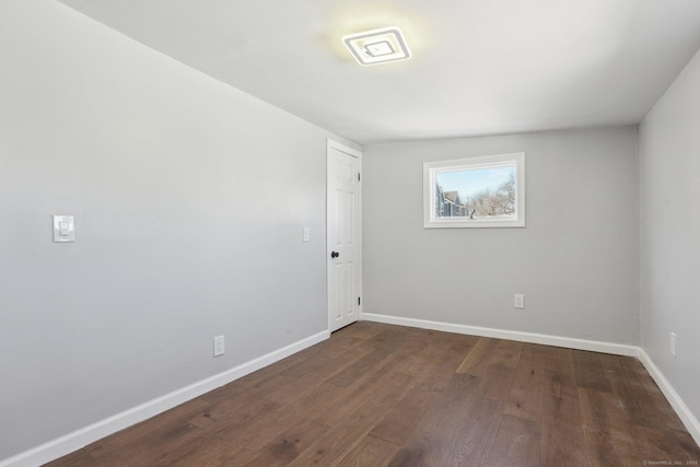 unfurnished room featuring dark wood finished floors and baseboards