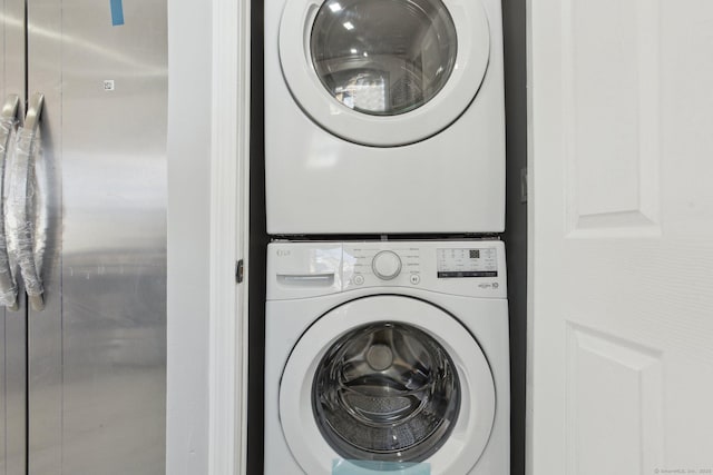 washroom featuring laundry area and stacked washer / dryer