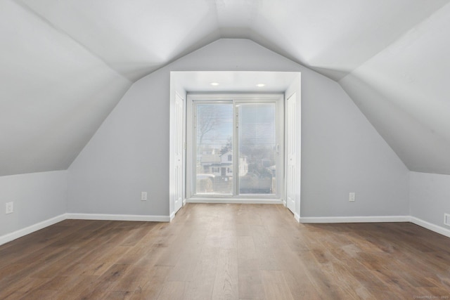 bonus room featuring vaulted ceiling, wood finished floors, and baseboards