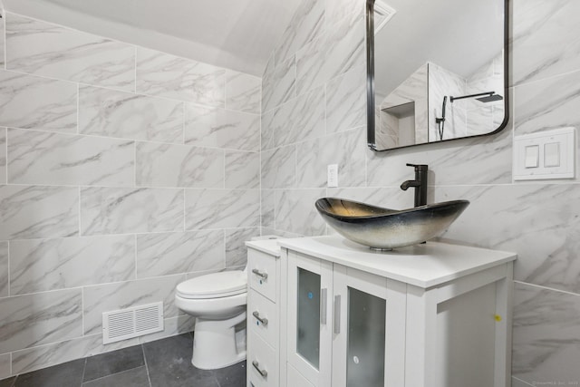 bathroom featuring visible vents, vanity, and toilet