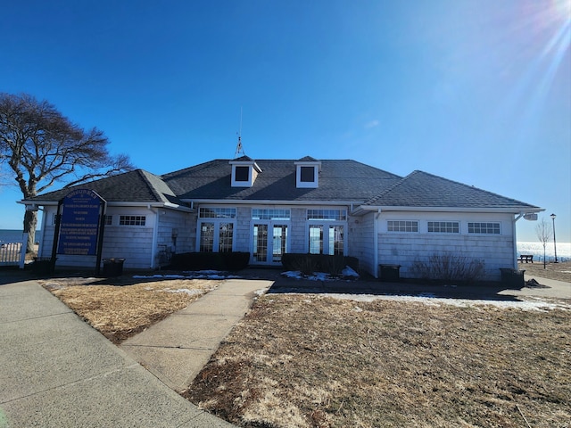 view of front of home featuring roof with shingles