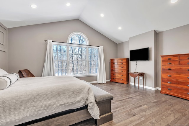 bedroom featuring lofted ceiling, light wood-type flooring, baseboards, and recessed lighting