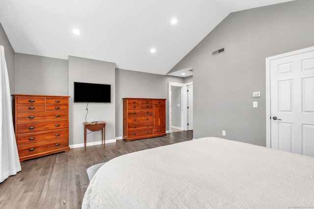 bedroom with baseboards, visible vents, wood finished floors, high vaulted ceiling, and recessed lighting