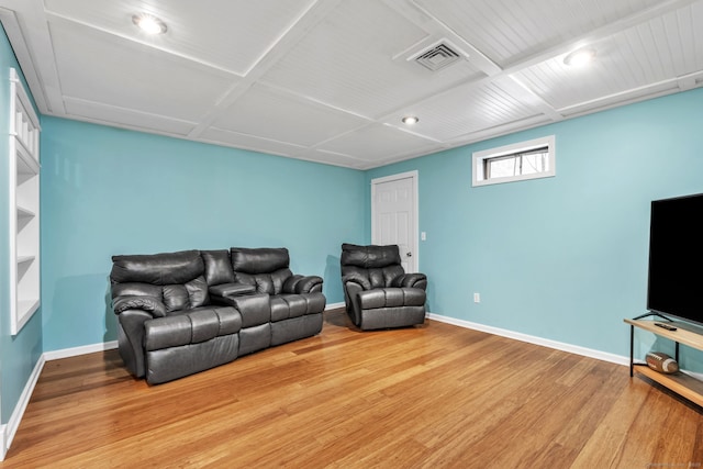 living room with visible vents, baseboards, and wood finished floors