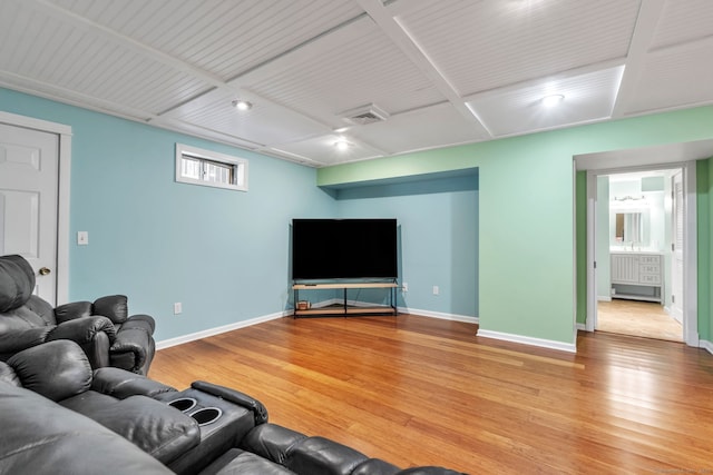 living room featuring wood finished floors, visible vents, and baseboards