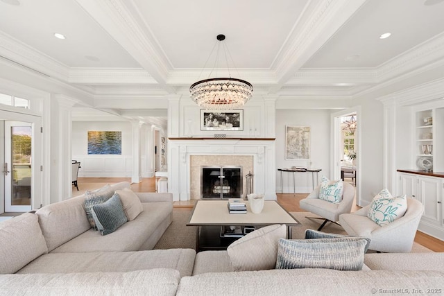260 Hillspoint Rd, Westport, CT 06880 - living room with crown molding, a fireplace, light wood finished floors, beamed ceiling, and ornate columns