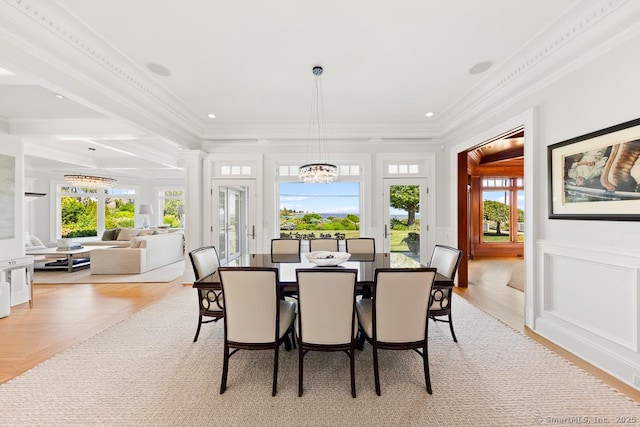 260 Hillspoint Rd, Westport, CT 06880 - dining space with a healthy amount of sunlight, an inviting chandelier, ornamental molding, and a decorative wall