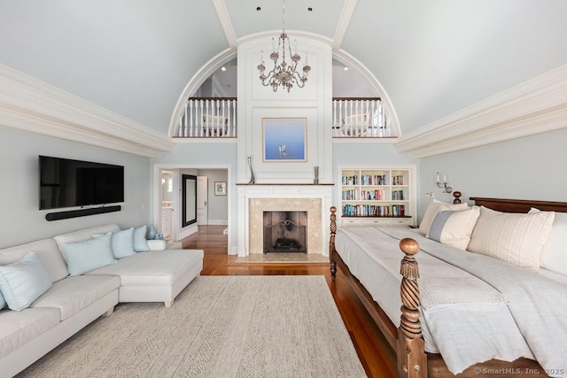 260 Hillspoint Rd, Westport, CT 06880 - bedroom with a chandelier, high vaulted ceiling, a fireplace, wood finished floors, and ornamental molding