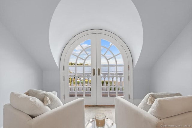 260 Hillspoint Rd, Westport, CT 06880 - living room featuring french doors, a water view, vaulted ceiling, and wood finished floors