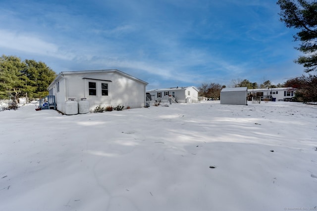 exterior space with a storage shed and an outbuilding