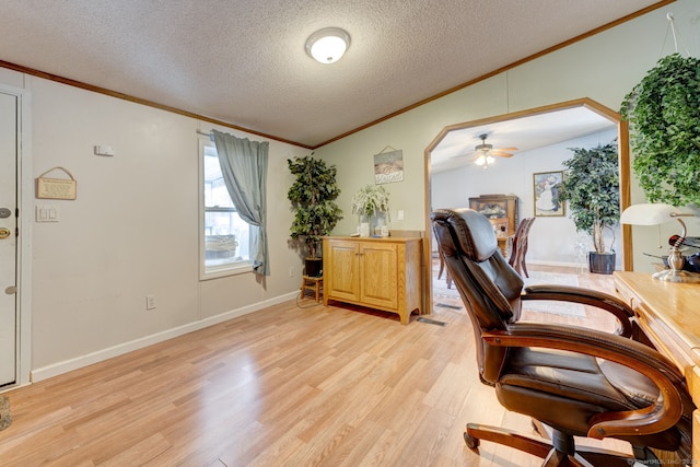 office area with crown molding, light wood-style floors, ceiling fan, a textured ceiling, and baseboards