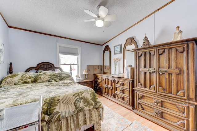 bedroom featuring light wood-style flooring, a textured ceiling, and crown molding