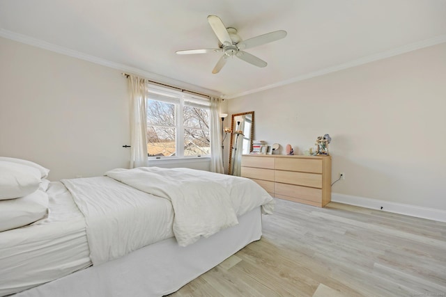 bedroom featuring ornamental molding, light wood-type flooring, ceiling fan, and baseboards