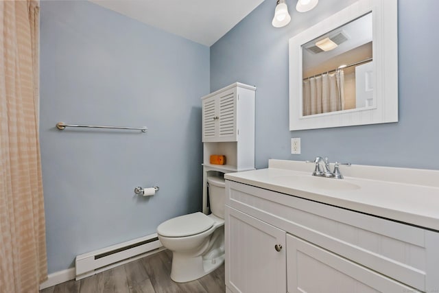 bathroom featuring toilet, wood finished floors, visible vents, vanity, and baseboard heating