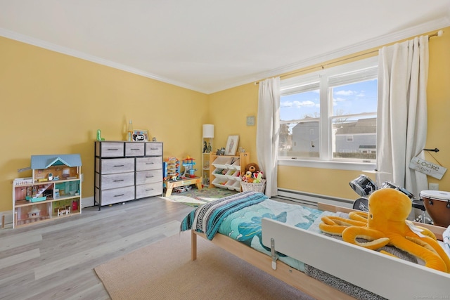 bedroom featuring light wood-type flooring, a baseboard heating unit, and crown molding