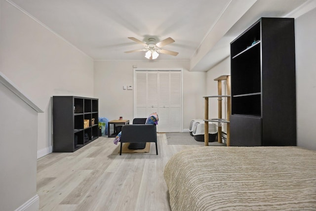 bedroom featuring ornamental molding, ceiling fan, baseboards, and wood finished floors