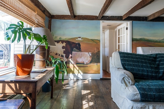 interior space featuring beam ceiling, a healthy amount of sunlight, and hardwood / wood-style floors