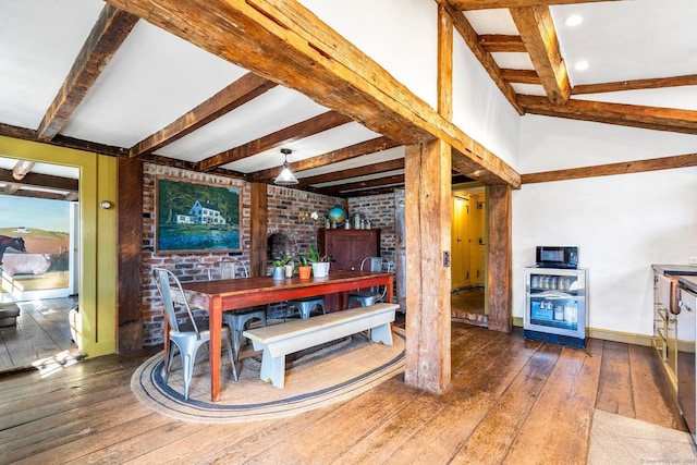 dining area with wine cooler, wood-type flooring, brick wall, beamed ceiling, and baseboards