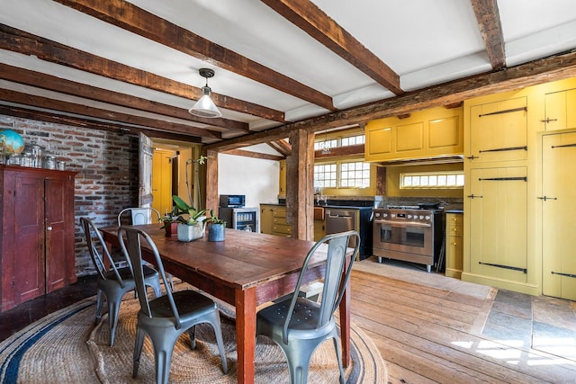 dining space featuring hardwood / wood-style flooring, brick wall, wine cooler, and beam ceiling