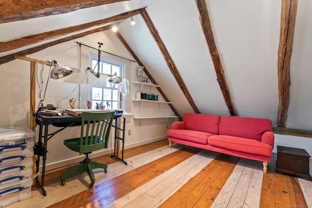 office featuring vaulted ceiling with beams, baseboards, and hardwood / wood-style flooring