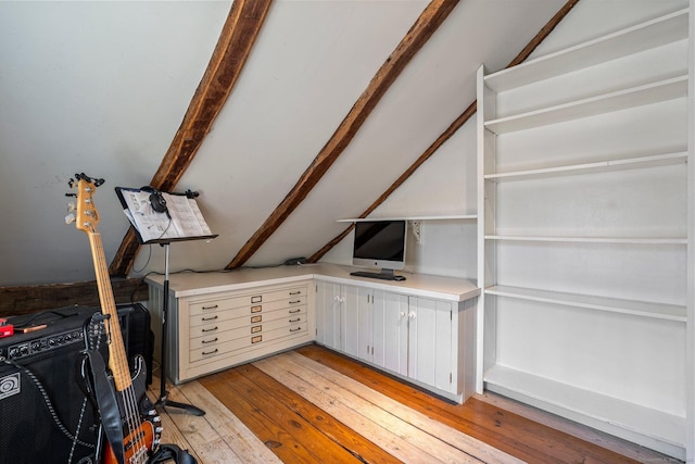 unfurnished office with lofted ceiling and light wood-style flooring