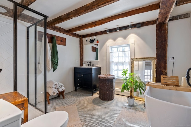 interior space with a freestanding bath, beam ceiling, a stall shower, and vanity