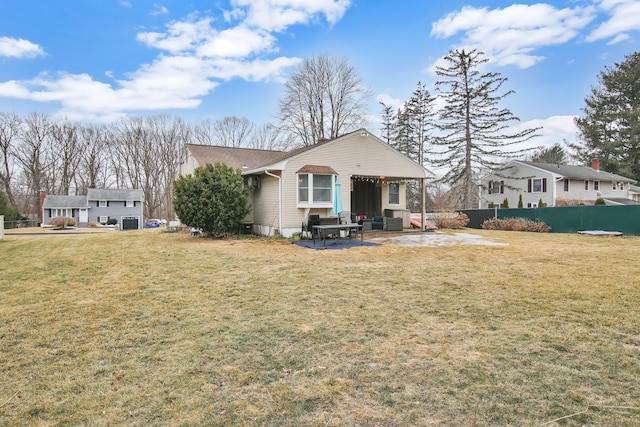 rear view of property with a patio, a yard, fence, and cooling unit